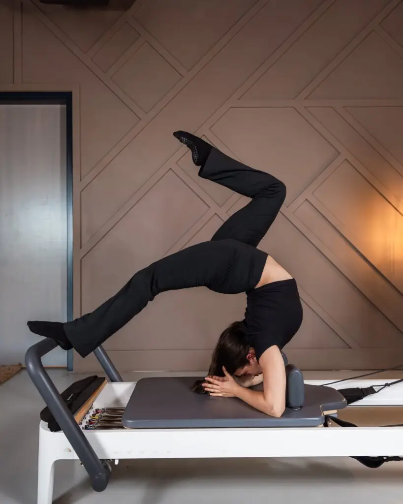 athletic woman on pilates reformer